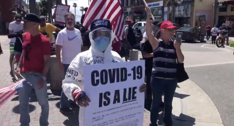 Internet laughs at protester whose sign says ‘COVID-19 is a lie’ — even though he's in full protective gear