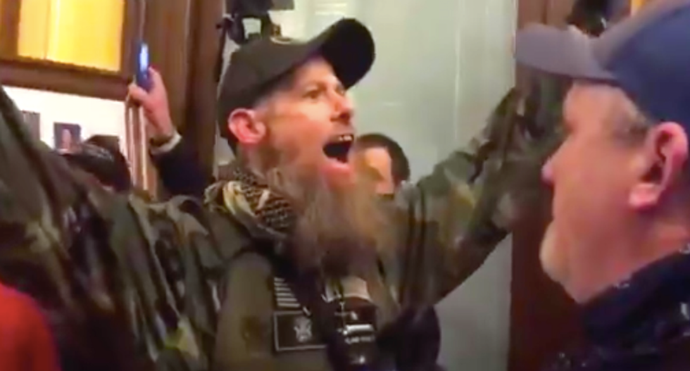 WATCH: Gun-toting Michigan protesters pack into statehouse to scream in one another’s faces
