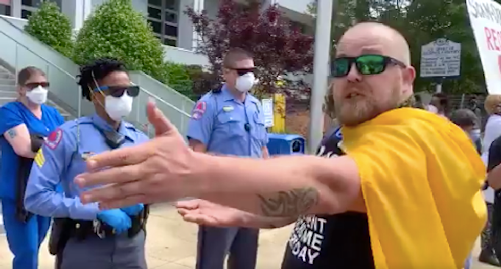 ‘Take me to jail!’ Reopen protester in Raleigh pesters black police officer during NC demonstration