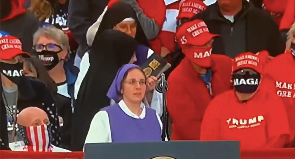 Nuns at Trump rally appear uncomfortable reading their Bible as president runs over an hour late to event