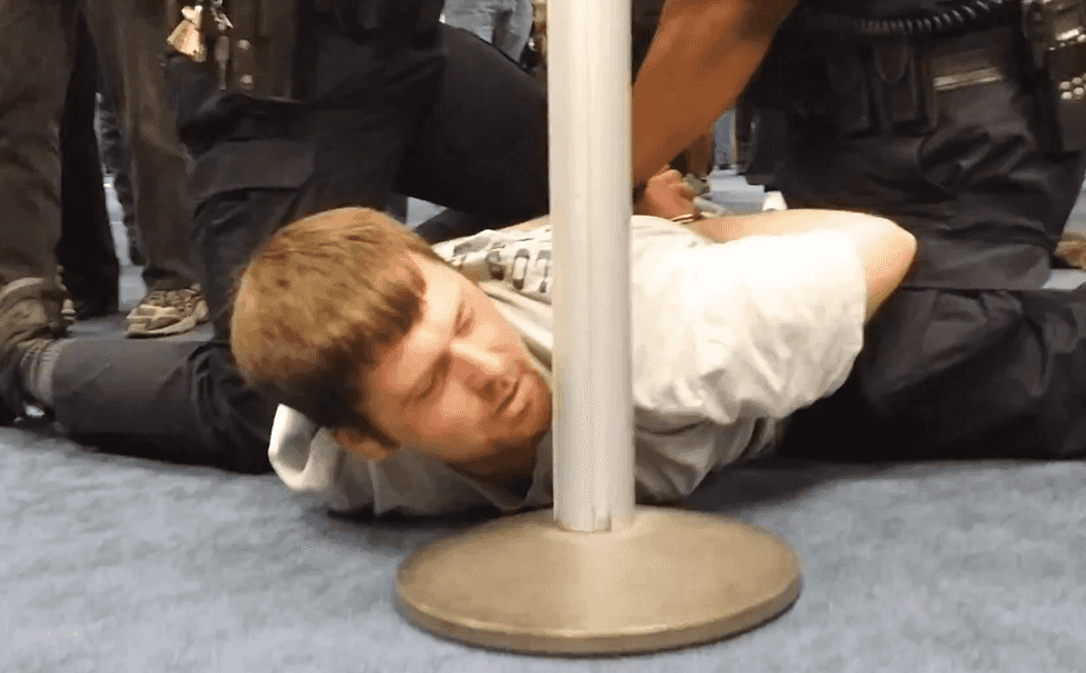 WATCH: Bystanders at Dallas Airport stop antigay attack by piling on drunk bully