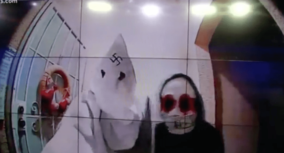 Shocking door cam video shows man in KKK hood with swastika on it
