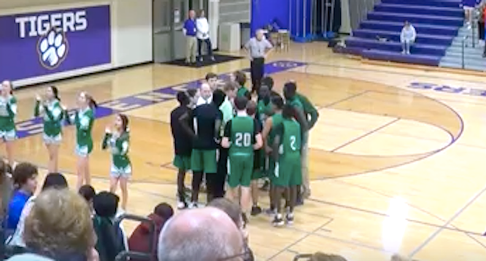 Flag-wearing white Iowa teens jeer black basketball players with racist insults -- and chant 'USA'