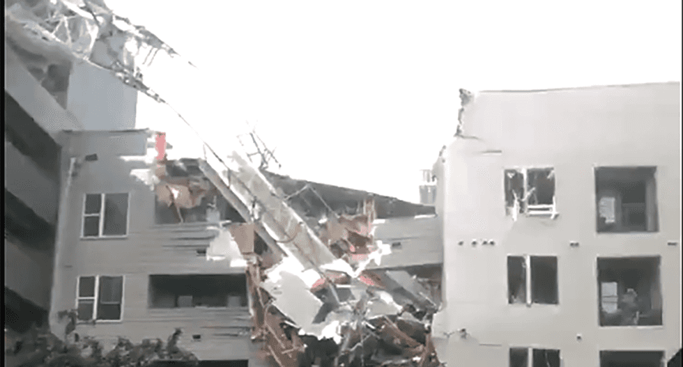 WATCH: One dead in crane collapses in Dallas -- slicing into building next to it