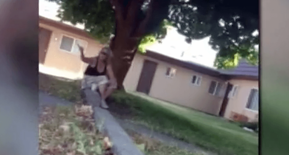 'I think you might be terrorists!' Woman charged after racist harassment of neighbor caught on video