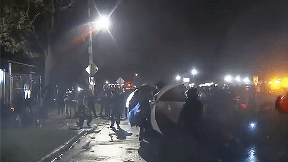 Brooklyn Center police throw flashbangs at kneeling protest crowd an hour before curfew