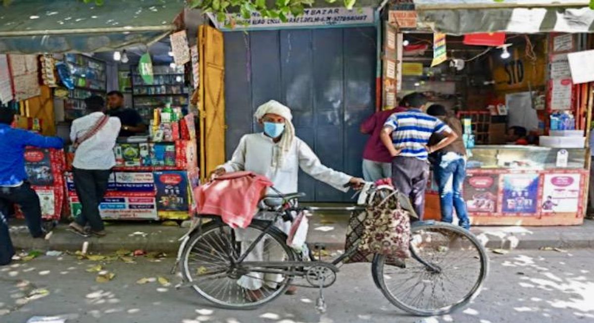 India locks down capital to battle virus as US hits vaccine milestone