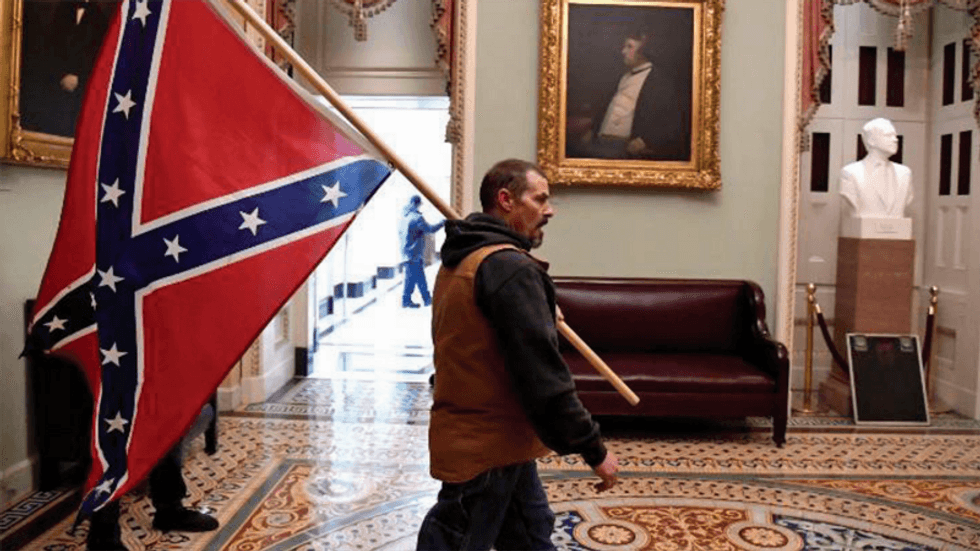 Confederate flag insurrectionist and his son allowed to take family road trip: judge