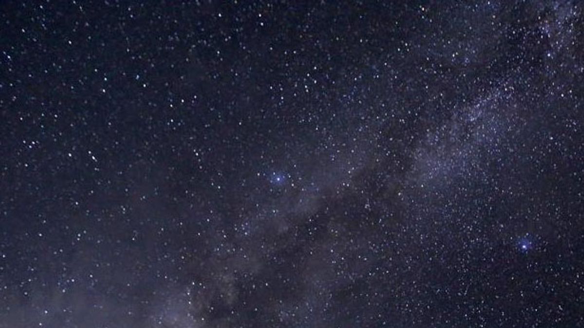 Why is space so dark even though the universe is filled with stars?