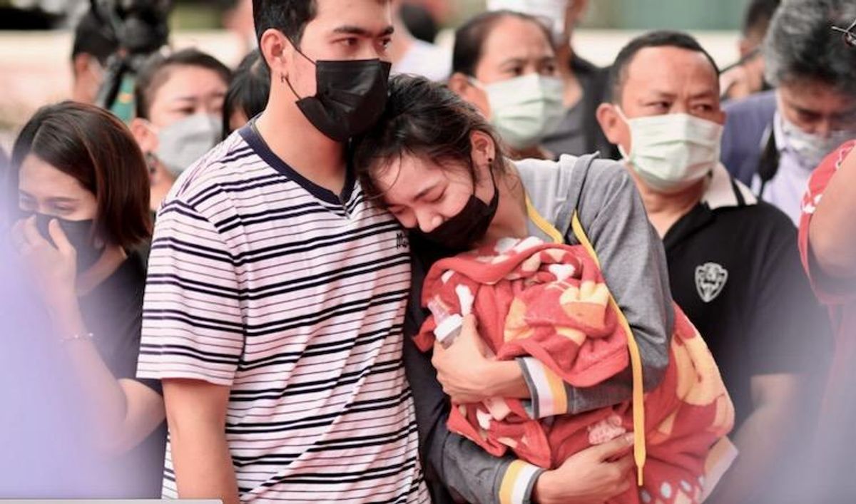 Distraught parents lay white roses for Thai nursery massacre victims