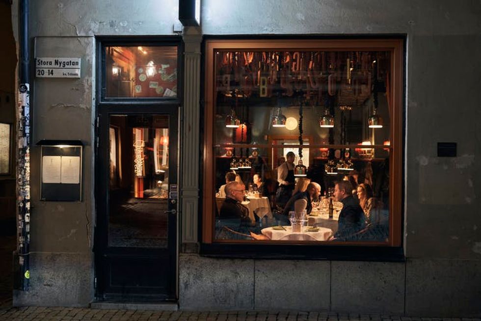 People sit at tables inside a small restaurant