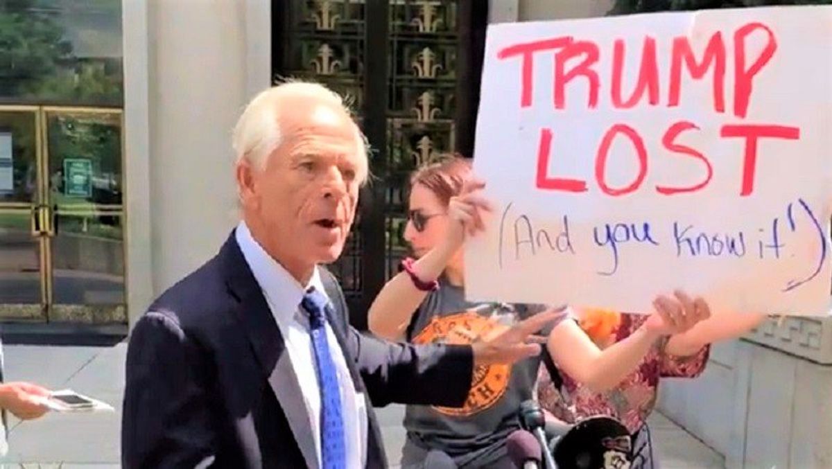 Watch: Peter Navarro spars with heckler holding 'Trump lost and you know it' sign