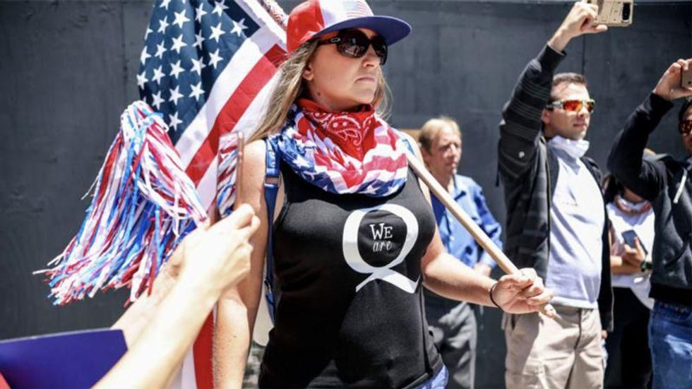 QAnon conspiracy theorists return to Dallas to wait for JFK Jr — and sing 'We are the World'