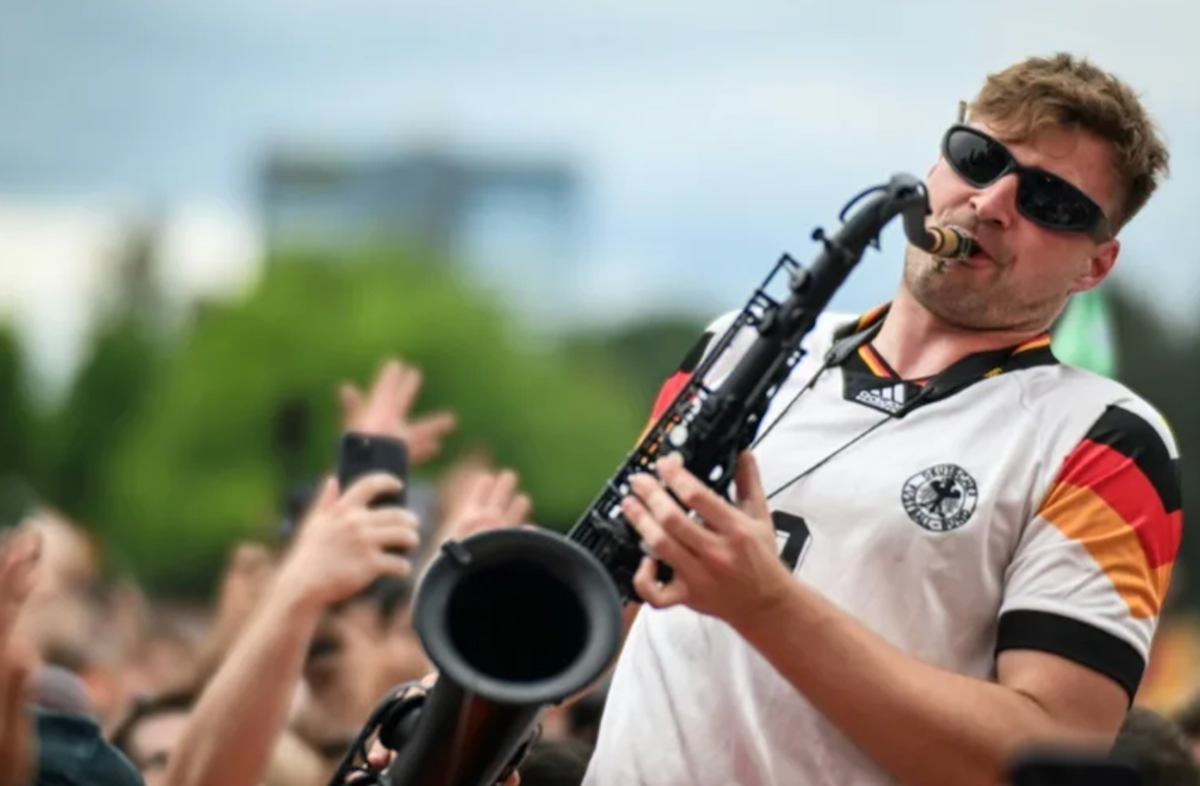 German fans dance to the tune of the 'saxophone guy'