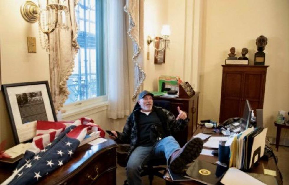 Jan. 6 rioter pictured putting feet on Pelosi's desk was lost and just trying to find a bathroom: lawyers