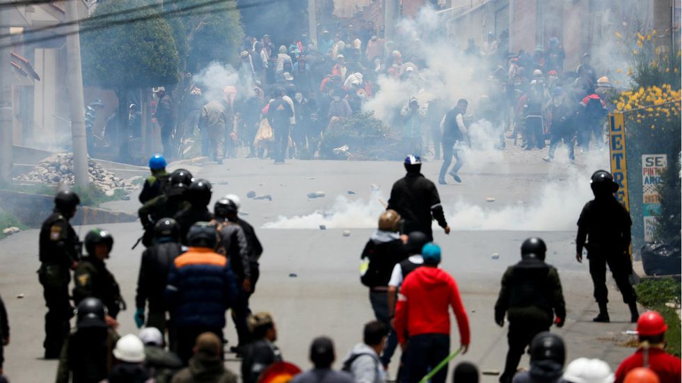 Supporters of Bolivian President Evo Morales and opposition supporters clash during a protest after Morales announced his resignation on Sunday, in La Paz Bolivia November 11, 2019.