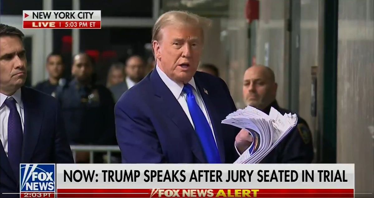 Trump awkwardly brandishes printed news stories after full day of criminal trial