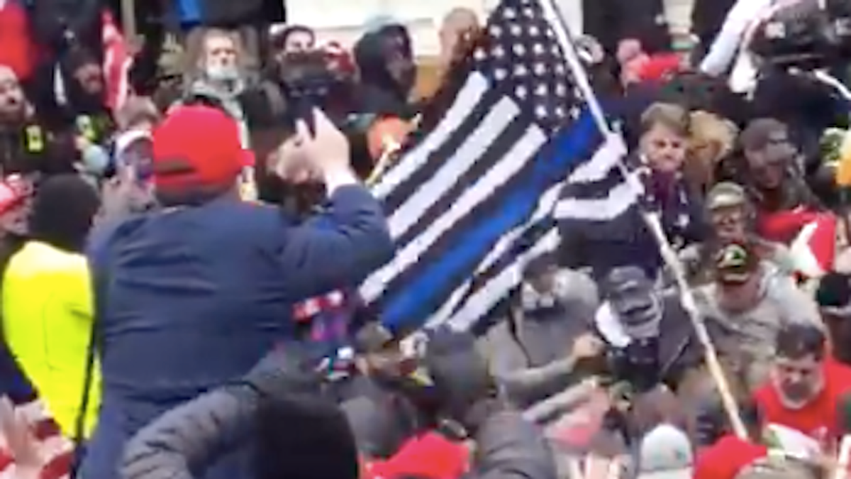 New video shows Trump supporters assaulting Officer Michael Fanone beneath 'Blue Lives Matter' flag