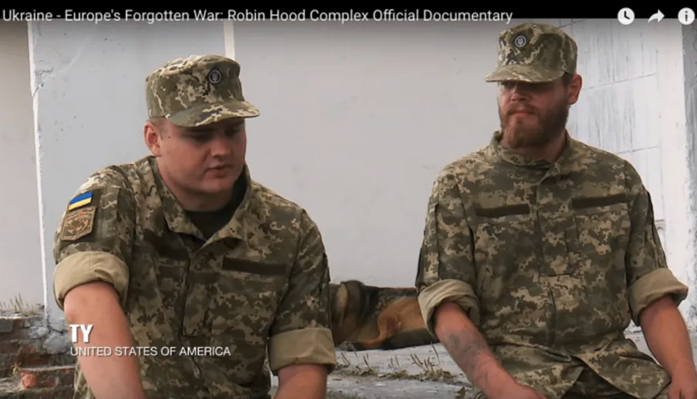 Ty Wingate Jones, seen with Norwegian volunteer Joachim Furholm, gives an interview to British documentary filmmaker Emile Ghessen at a training camp outside of Kyiv. (screenshot)