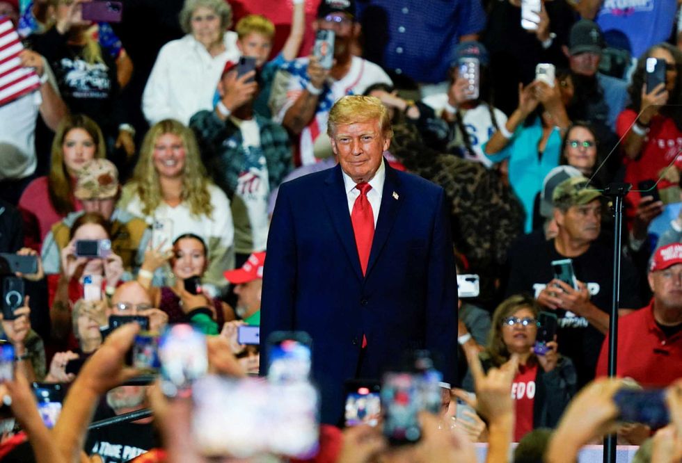 MAGA fan rushes back to Trump rally in hospital gown after having a seizure