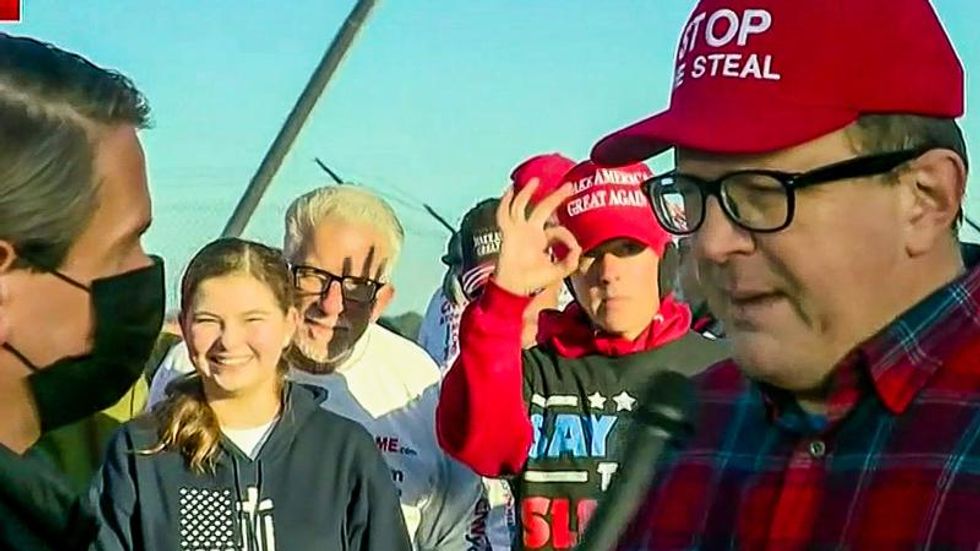 Fox News cuts video feed as Trump supporter flashes white power sign at Georgia GOP rally