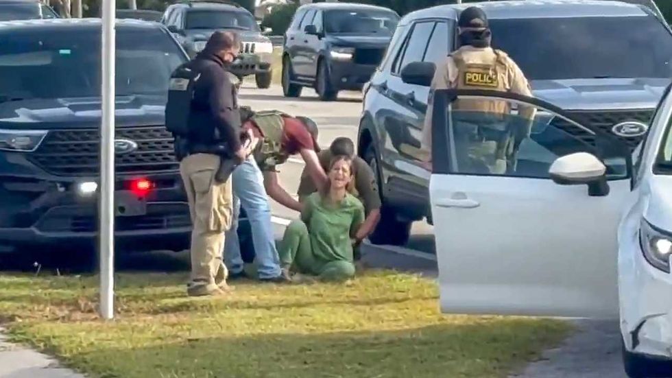 Feds forcibly yank woman in medical scrubs from car as she screams she's a US citizen