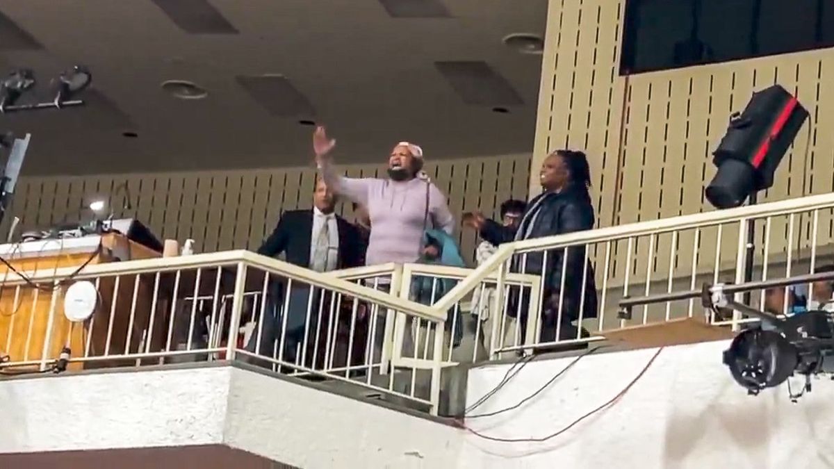 'The House is on fire!' Woman interrupts Dem's town hall to oppose 'business as usual'